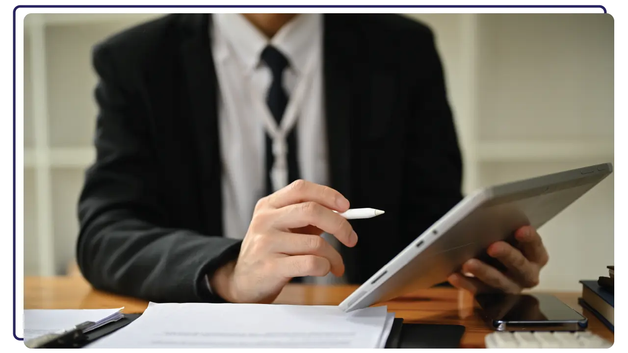 man holding an ipad - register company in Bahrain