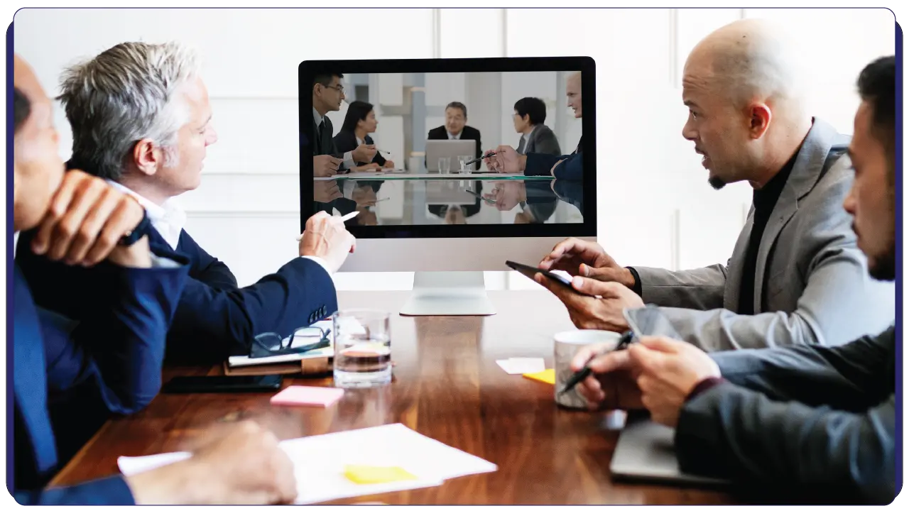 men sitting across the table in a meeting - software development company in Bahrain